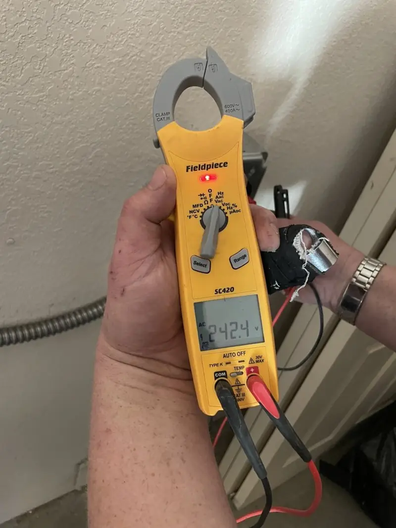 Voltage testing with clamp meter during Electrical Installation Services in Belleview